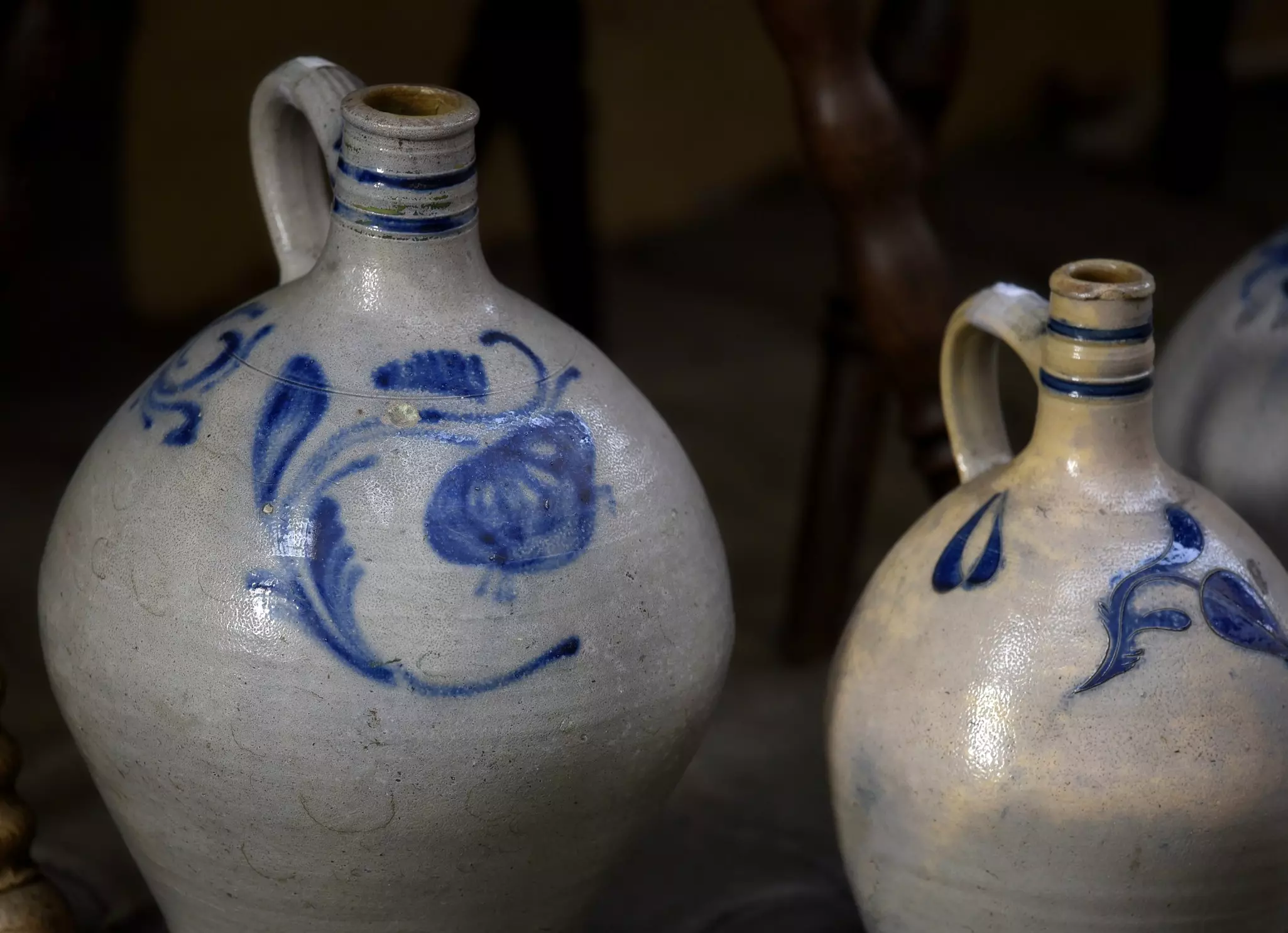 Antique handmade blue cobalt and grey glazed Betschdorf stoneware pots and pitchers on display in Obernai, Alsace France.