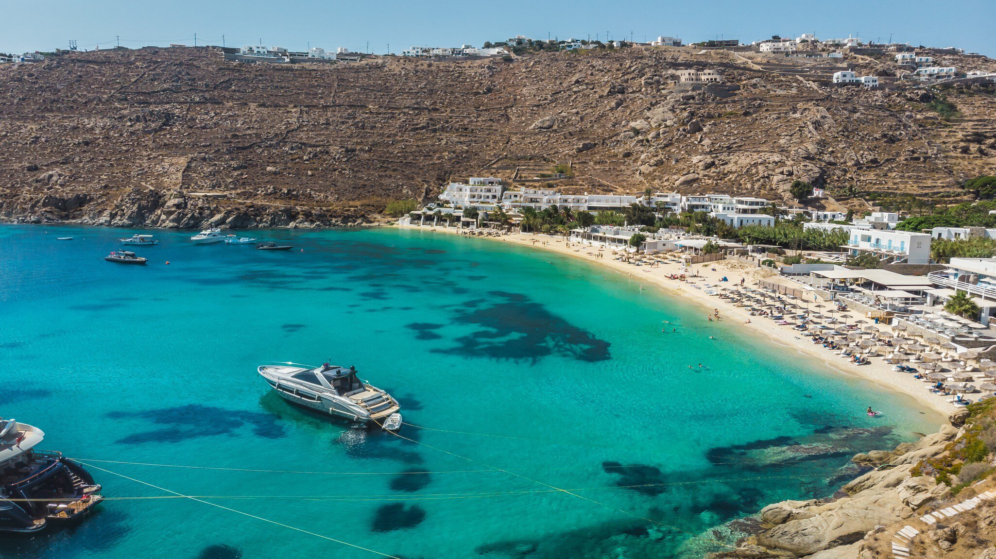 Aerial view over Psarou Bay on the island of Mykonos in Greece.