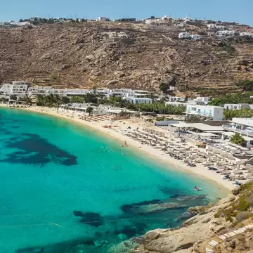 Aerial view over Psarou Bay on the island of Mykonos in Greece.