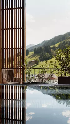 A pool with a valley in the background.