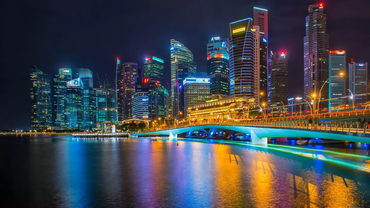 Commercial skyscrapers in Marina Bay and Merlion Park at night time of Singapore.