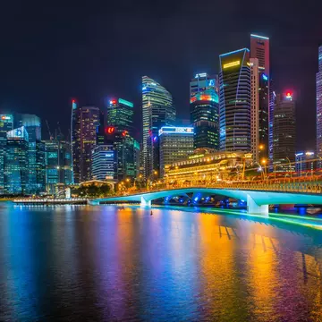 Commercial skyscrapers in Marina Bay and Merlion Park at night time of Singapore.