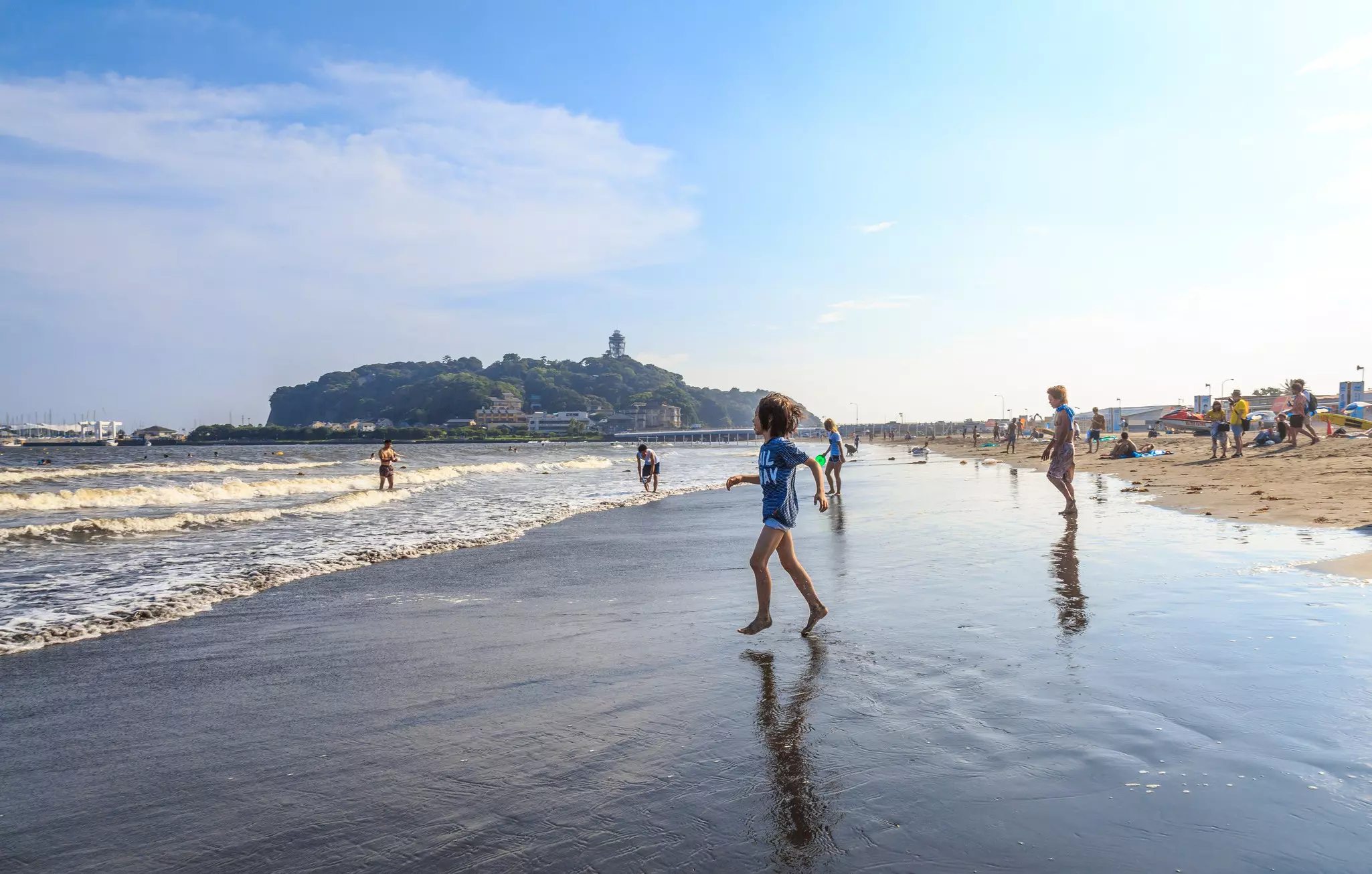 A boy is going to the Katase Higashihama beach against sky, Fujisawa-kanagawa, Japan