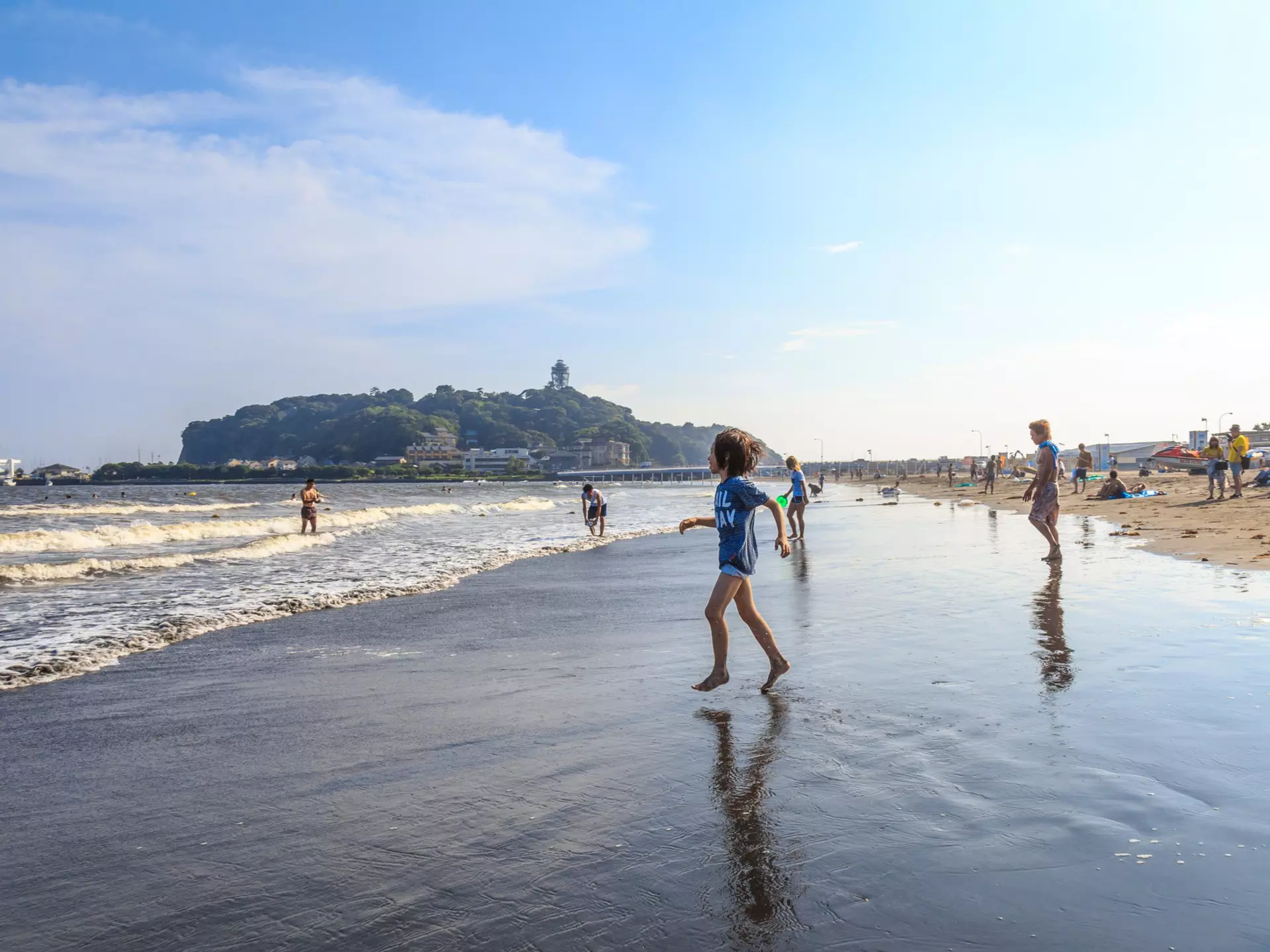 A boy is going to the Katase Higashihama beach against sky, Fujisawa-kanagawa, Japan