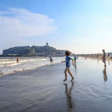 A boy is going to the Katase Higashihama beach against sky, Fujisawa-kanagawa, Japan