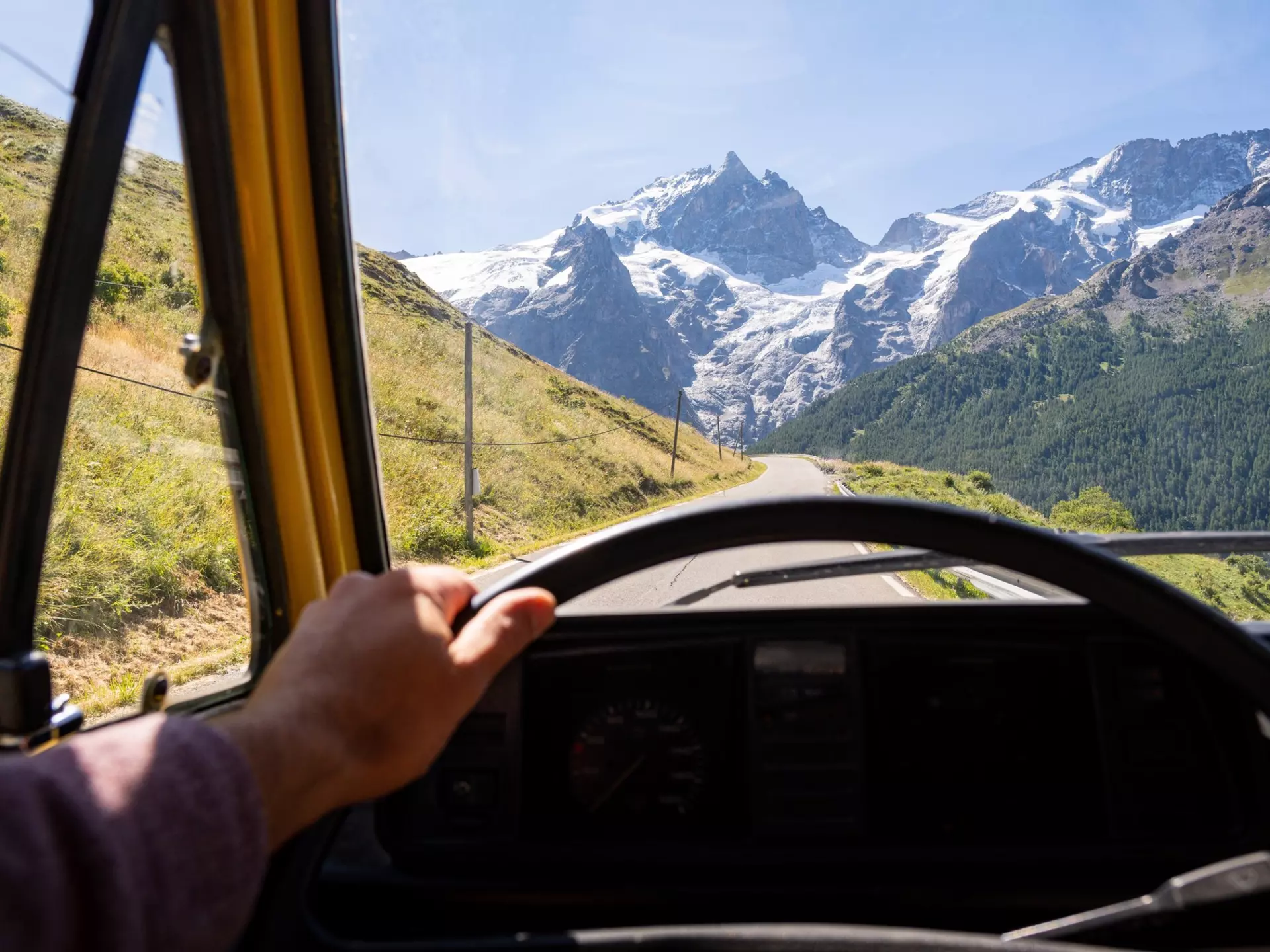 Driver seat view over the Alps mountains. Driving retro van along the roads of Ecrins National Park, France., License Type: media, Download Time: 2025-05-22T19:05:42.000Z, User: tasminwaby56, Editorial: false, purchase_order: 65050 - Digital Destinations and Articles, job: Online Editorial, client: French Alps summer itinerary, other: Tasmin Waby