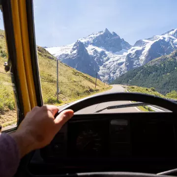 Driver seat view over the Alps mountains. Driving retro van along the roads of Ecrins National Park, France., License Type: media, Download Time: 2025-05-22T19:05:42.000Z, User: tasminwaby56, Editorial: false, purchase_order: 65050 - Digital Destinations and Articles, job: Online Editorial, client: French Alps summer itinerary, other: Tasmin Waby