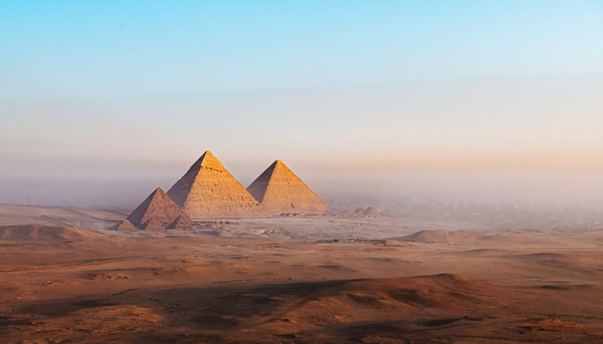 A view over the desert to the Pyramids of Giza, Egypt.