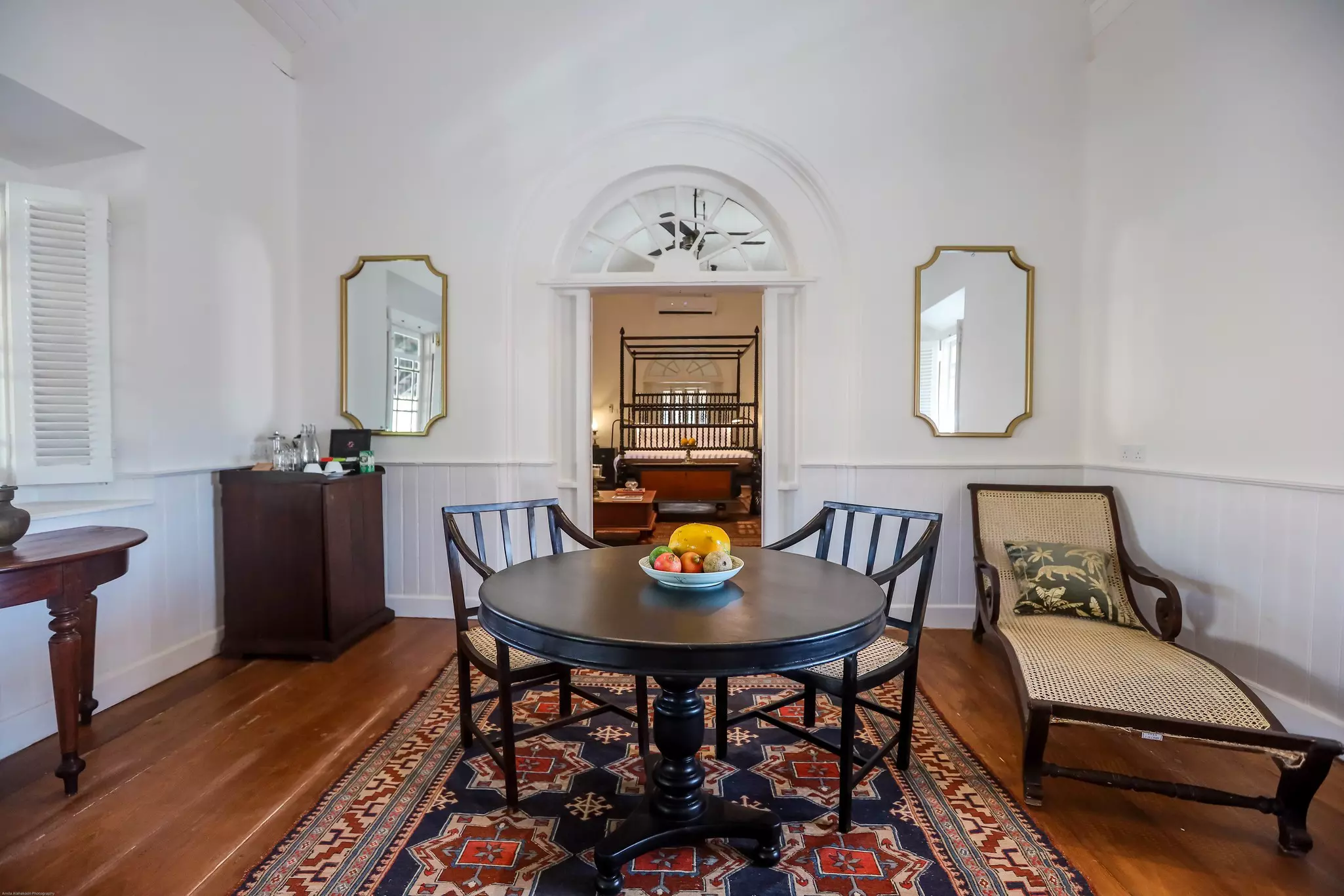 A luxurious hotel suite with vintage furniture.