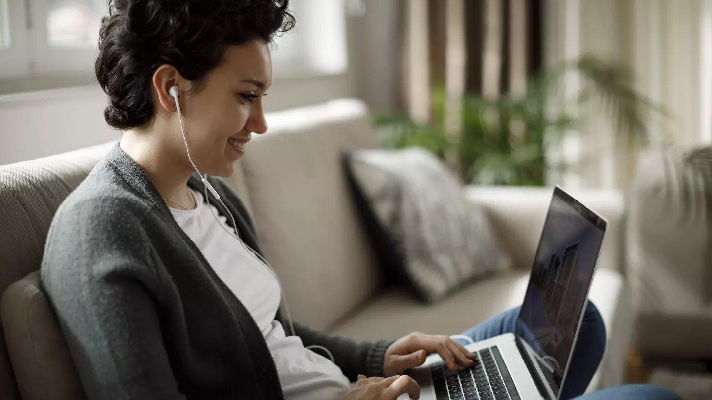 Young woman enjoying good music while working on laptop
1170984232
content