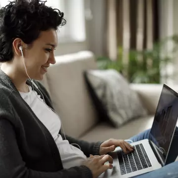 Young woman enjoying good music while working on laptop
1170984232
content
