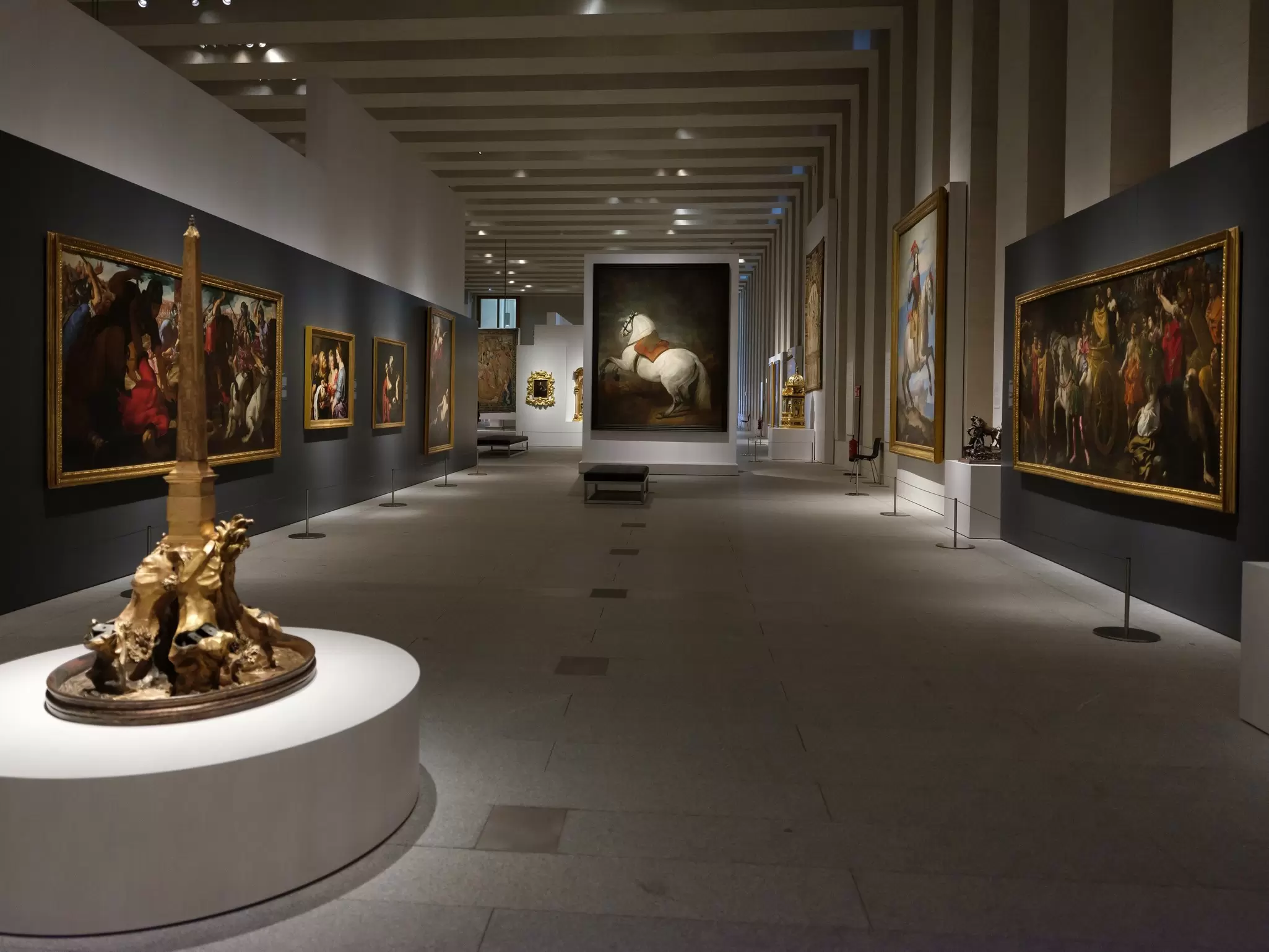 View of an exhibition at the Galería de las Colecciones Reales, with Velázquez's White Horse painting in the background, in Madrid, Spain.