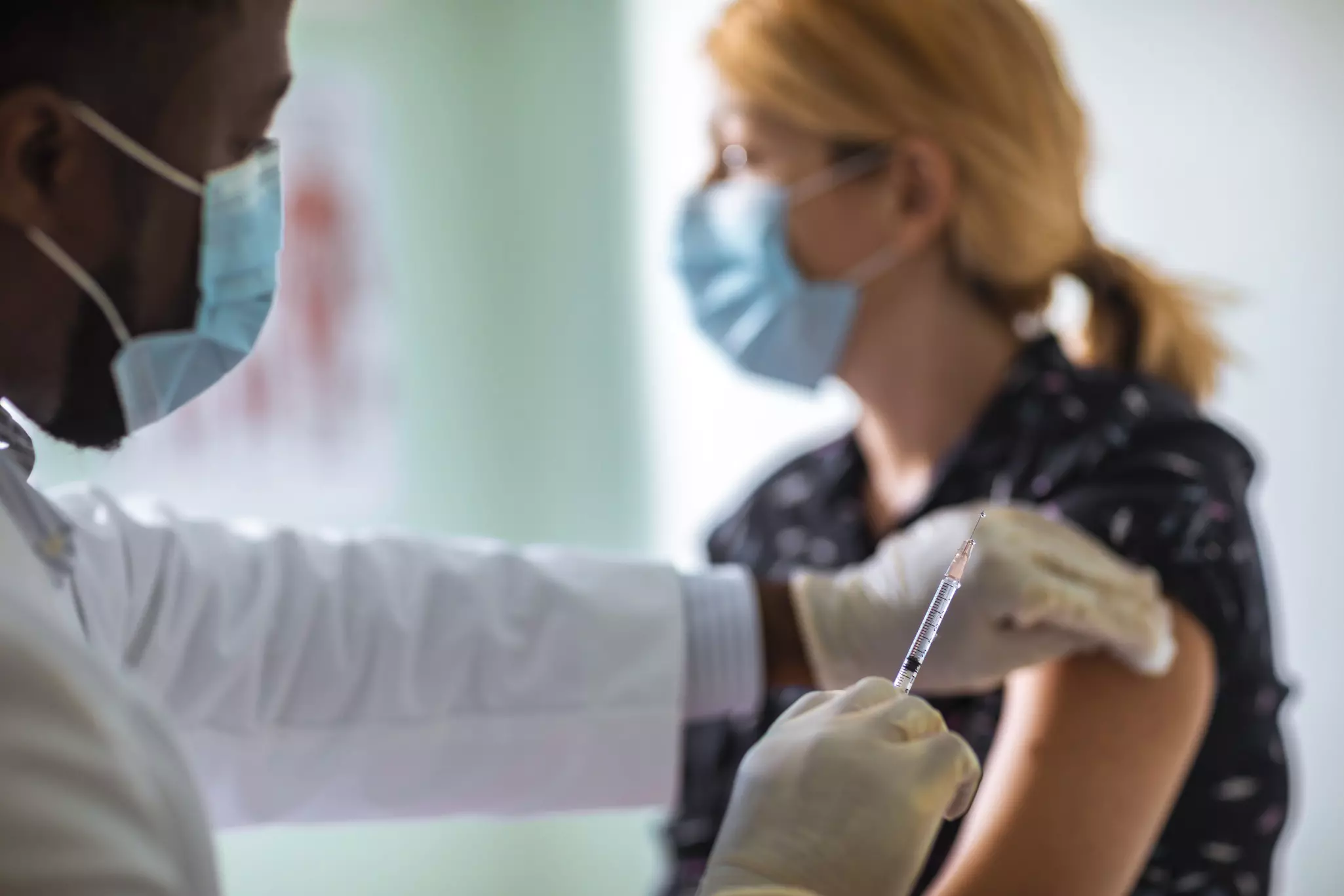 A young woman is getting vaccinated.