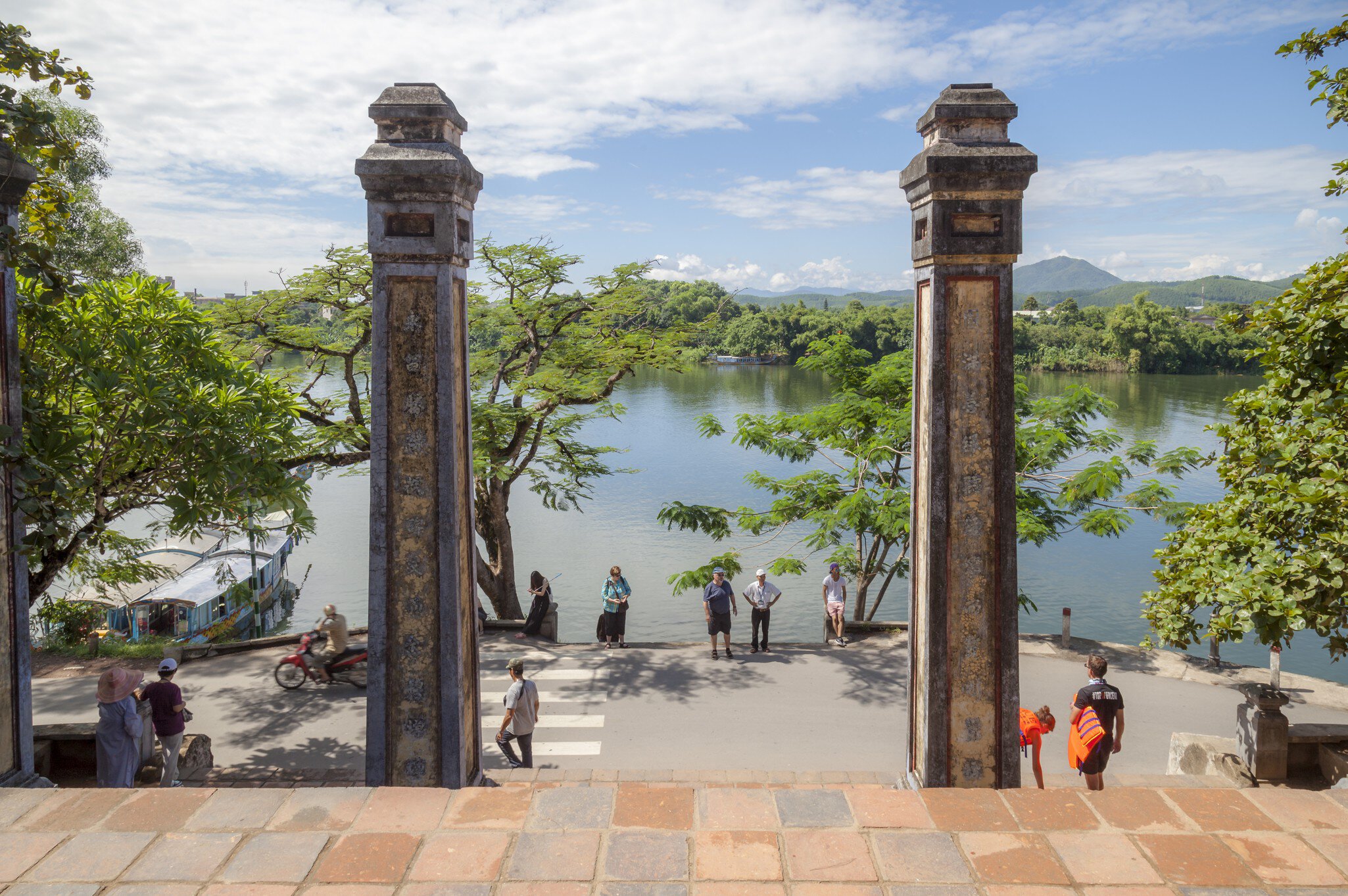 Tourists sightseeing, pilgrim on a summer morning at Thien Mu Pagoda, Hue, Vietnam.