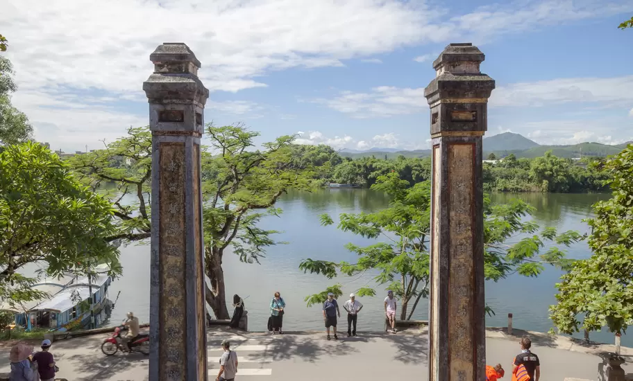 Tourists sightseeing, pilgrim on a summer morning at Thien Mu Pagoda, Hue, Vietnam.