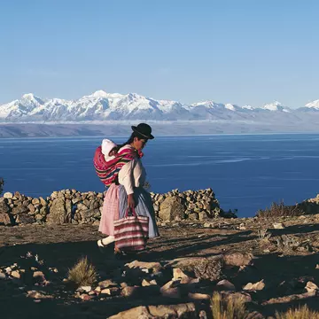 A Bolivian woman walking in front of Lake Titicaca
521862542
mother:CB2, two people:CB1, traditional clothing:CB2, women:CB2, side view:CB1, Bolivian:CB2, island:CB2, lakeshore:CB2, baby carrier:CB2, bag:CB2, landforms:CB2, snow:CB2, infant:CB2, mountain range:CB2, wall:CB2, Isla del Sol:CB2