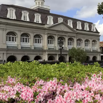 Exterior view of the Presbytère, framed by flowers in New Orleans, Louisiana.