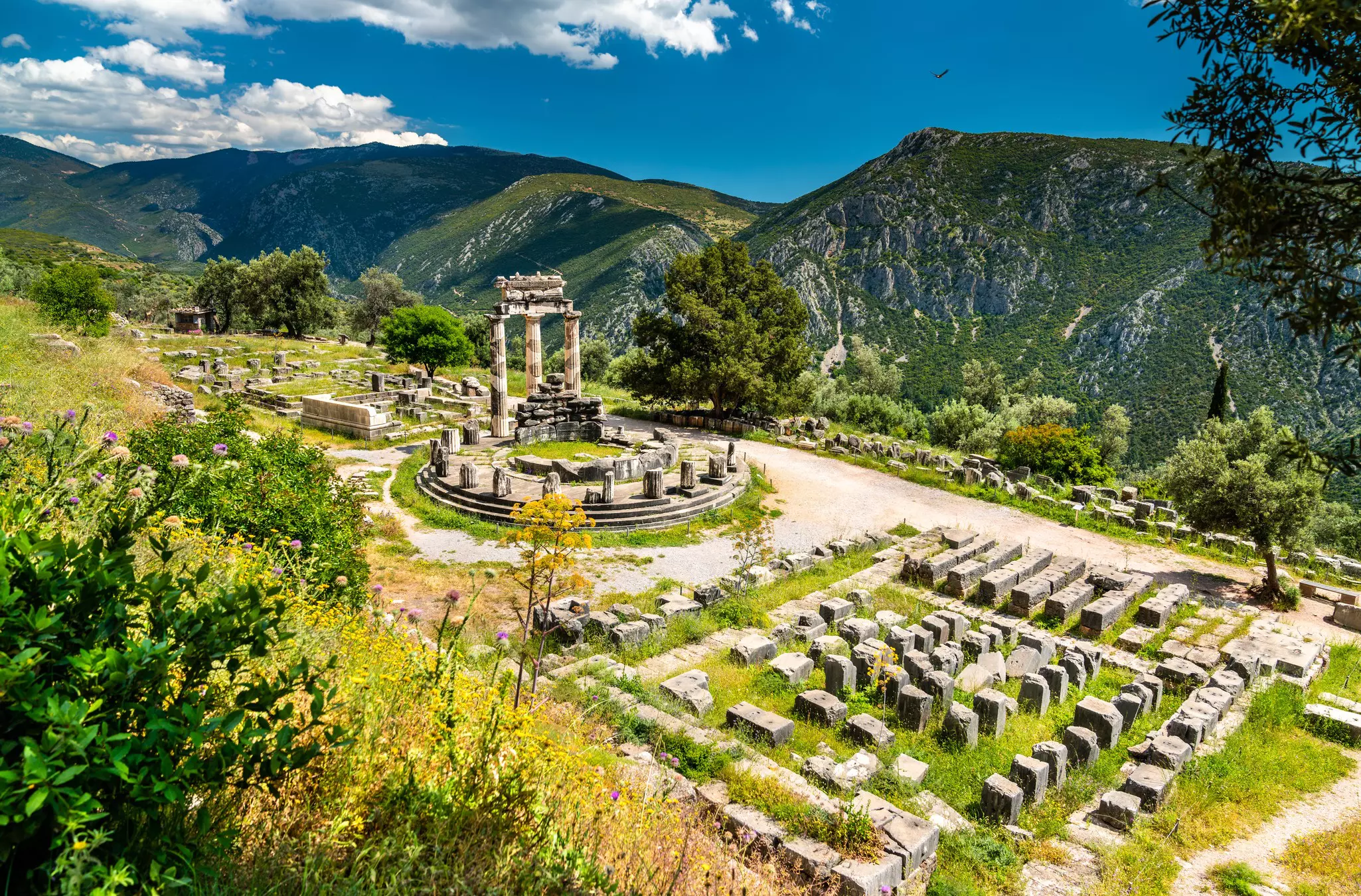 A temple and ruins in a green valley