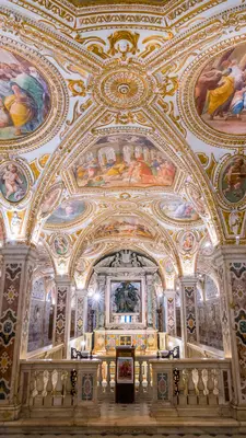 Colorful and elaborate decoration on the vaulted ceiling of a crypt in Italy.