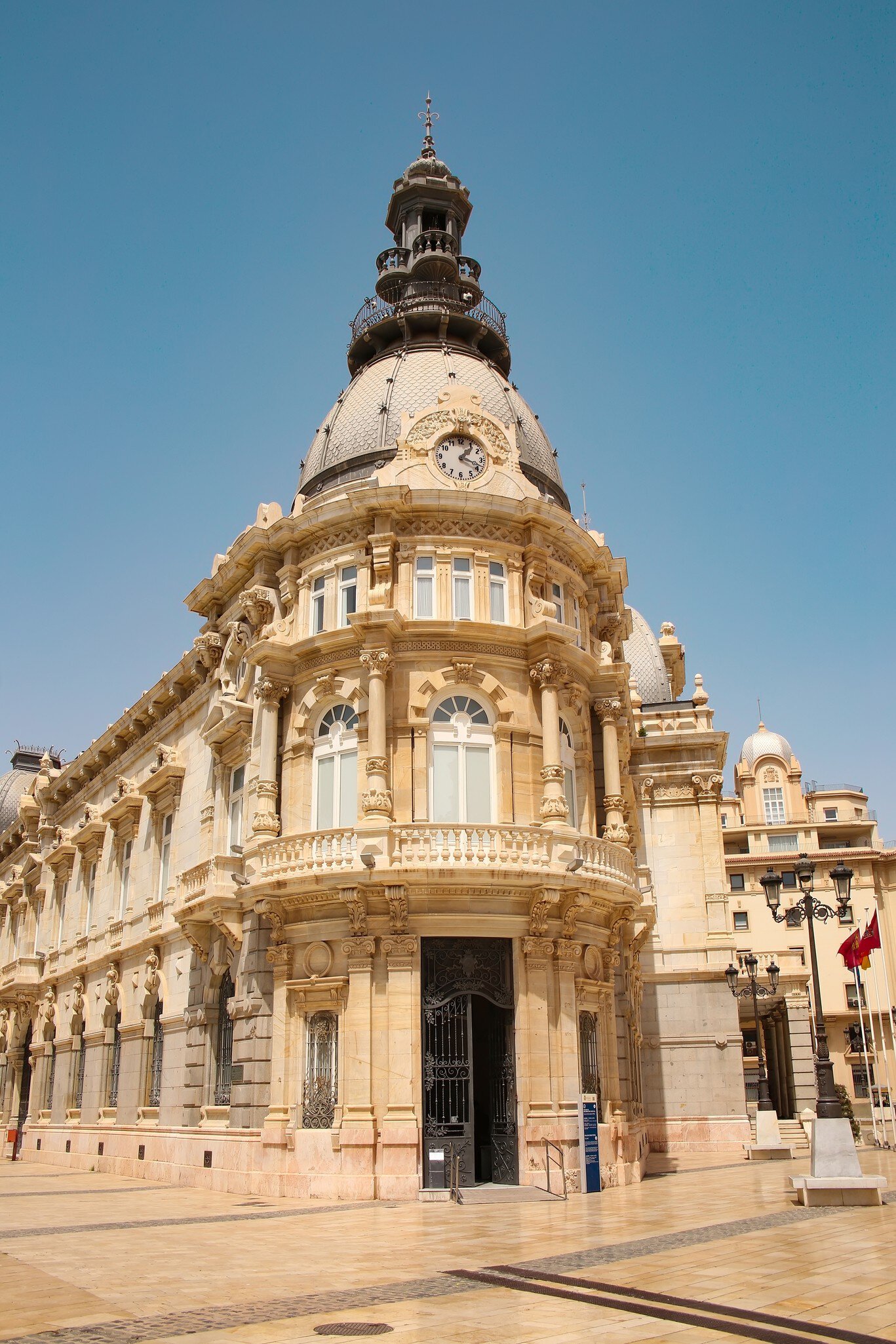 Town Hall under a cloud dappled blue sky with palm trees and roses, Cartagena, Murcia Region, Spain, Europe