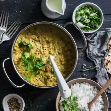 Top view of Indian dhal with jasmine rice, coriander and whole grain flatbread