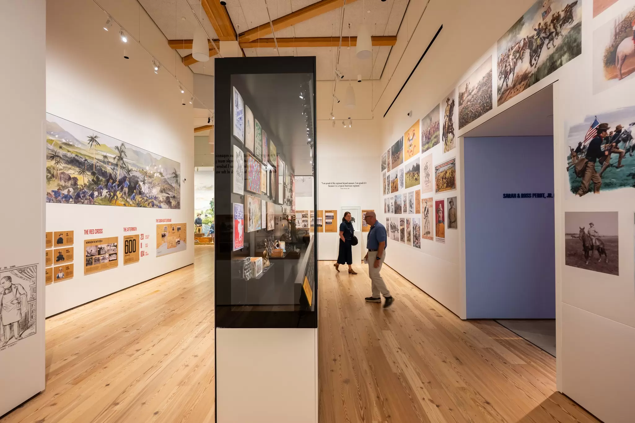 People mill around the gallery at the Theodore Roosevelt Presidential Library