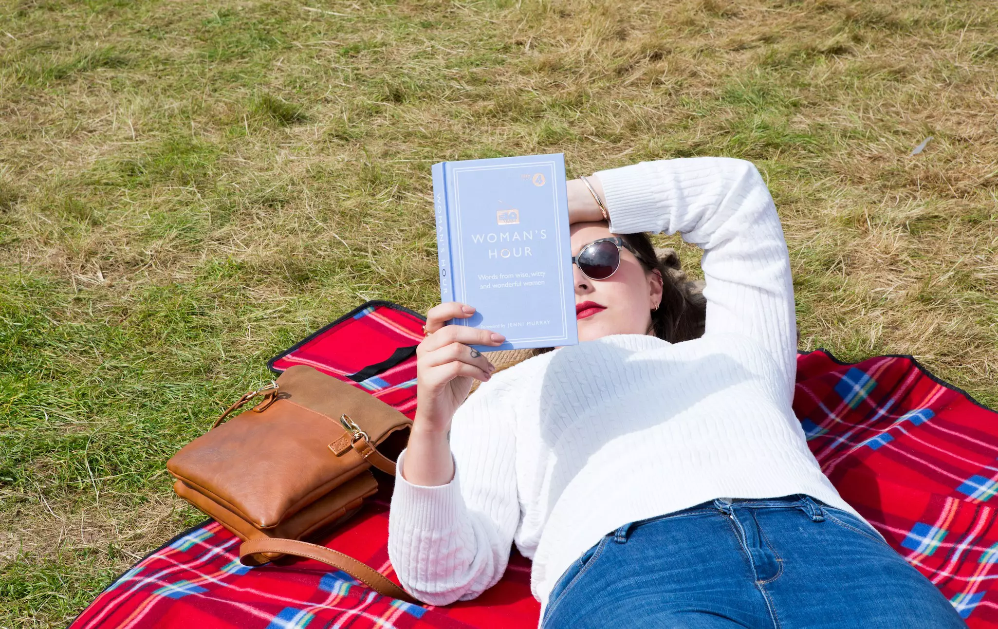 A woman relaxing with a book at the Hay Festival in Hay on Wye.