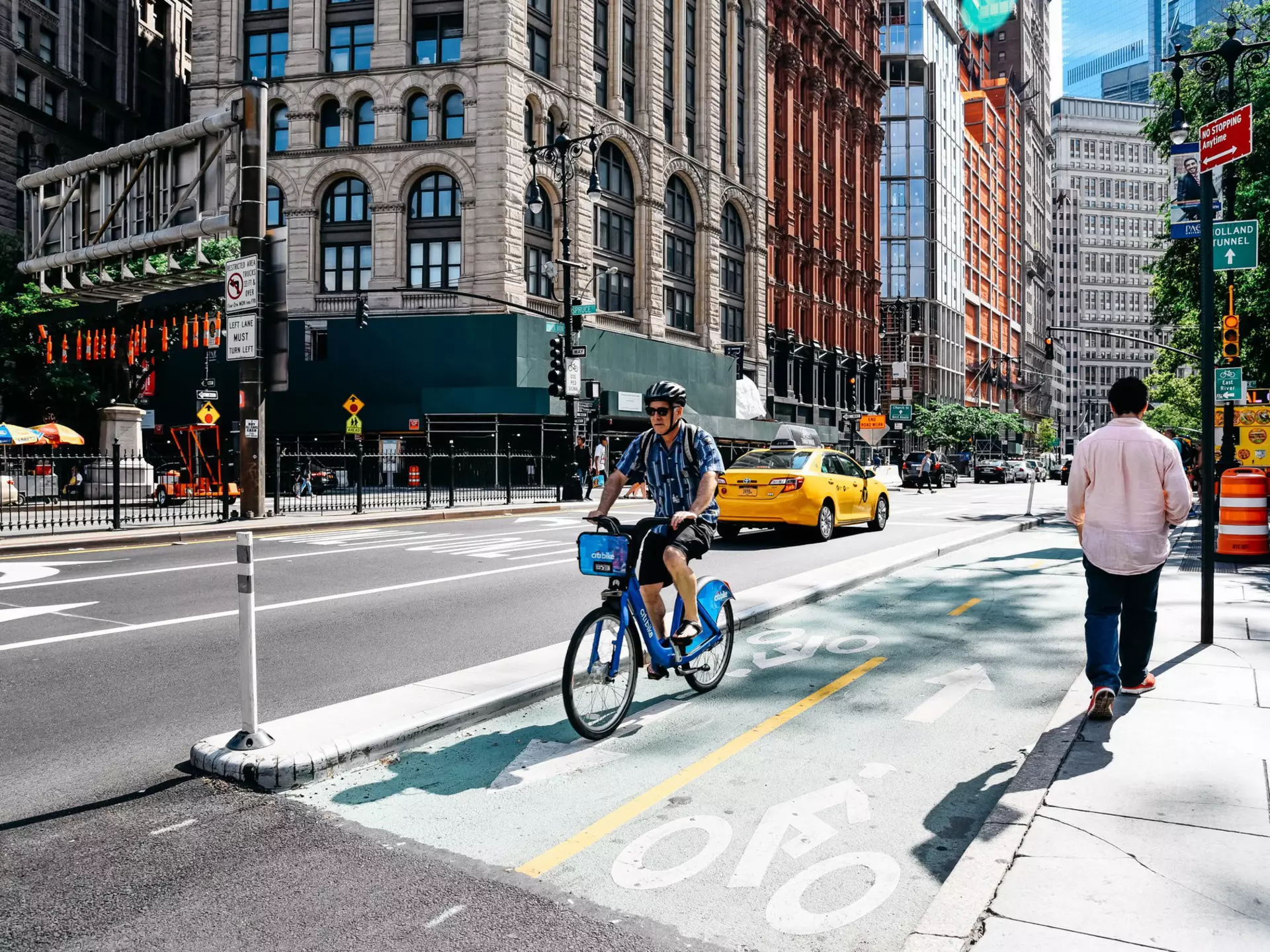 Cyclist riding in a bike lane at the Park Row financial district