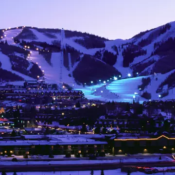 Overhead of Park City Ski Resort and ski runs, illuminated at dusk.