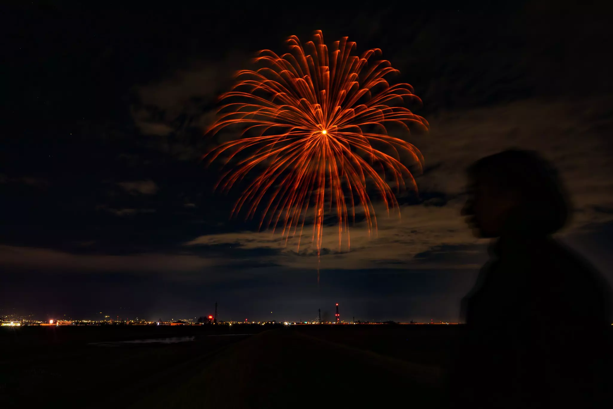 Wabi fireworks over a dark landscape