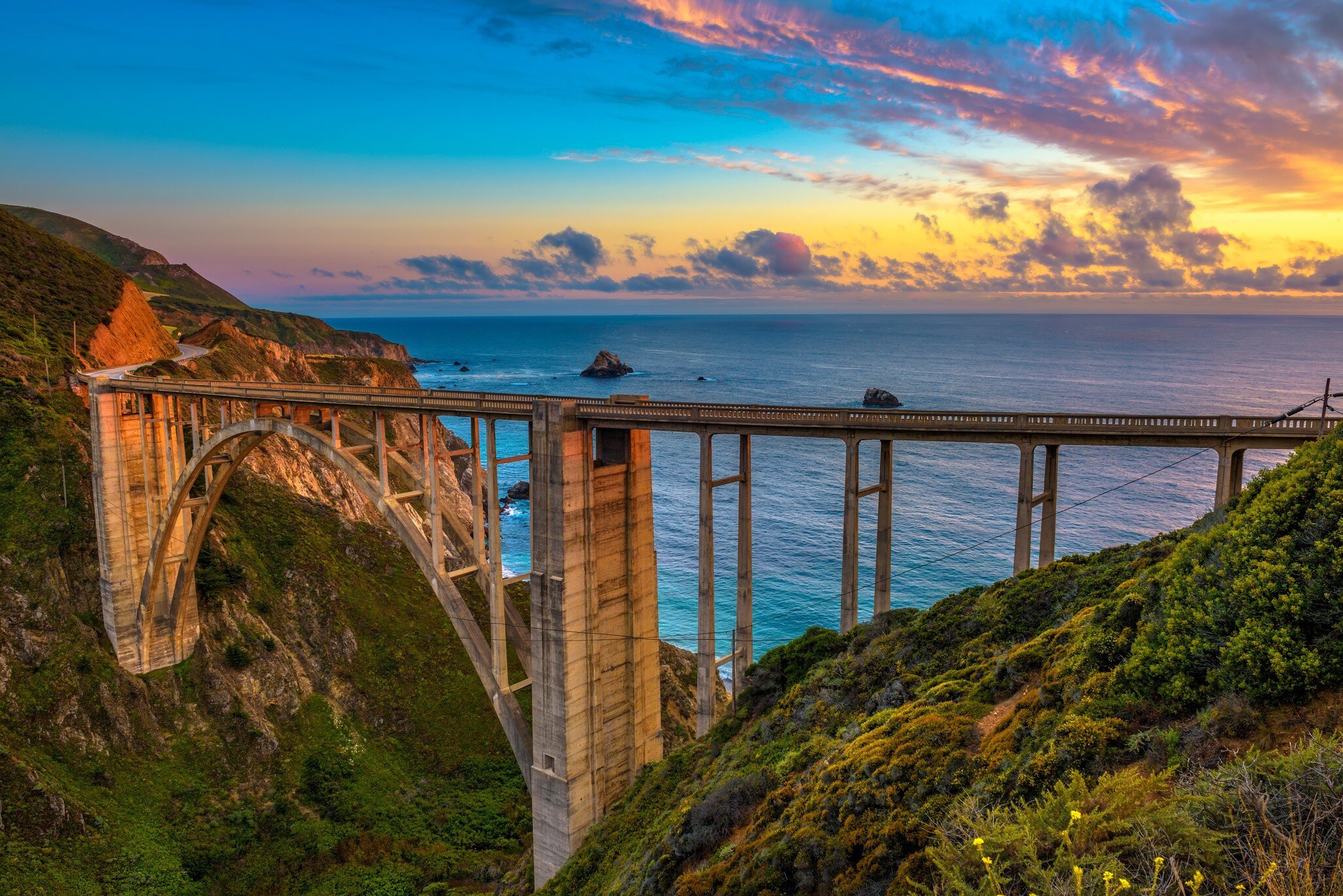 Bixby Bridge spans the Pacific Coast Highway at sunset near Big Sur in California, USA.