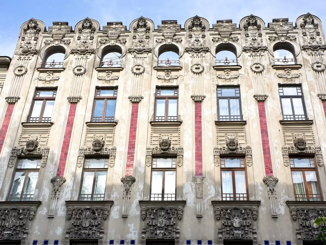 An Art Noveau–style building with stone and tile exterior.