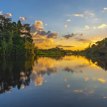 Reflection of a sunset by a lagoon in the Amazon