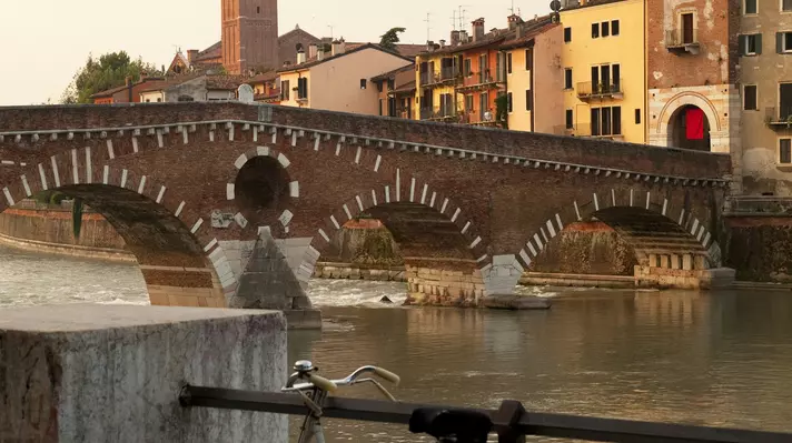 Bicycle parked on Ponte Pietra bridge in Verona