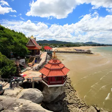 The temple and beach at Khao Tao are just one of the top day trip options from Hua Hin. Alexander Shalamov / Getty Images