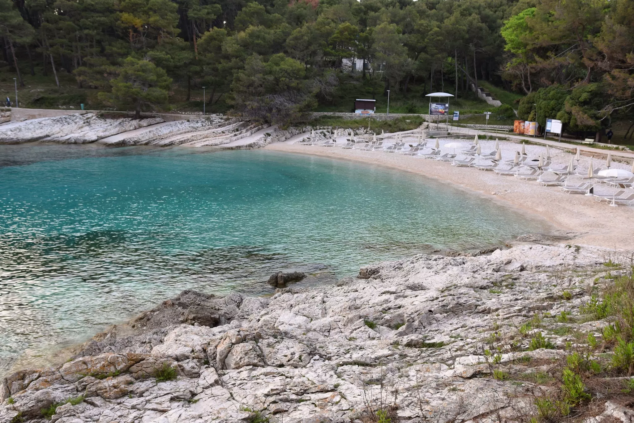 Loungers on the beach at Sunčana Uvala on Lošinj Island. 