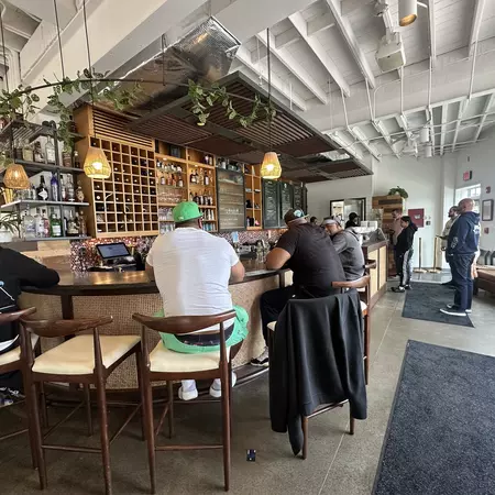 Men enjoying their meal sitting a restaurant bar