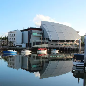 Bullwinkles Nightclub and Museum of Tropical Queensland (pictured at right) with reflection in water, Townsville. Australia
