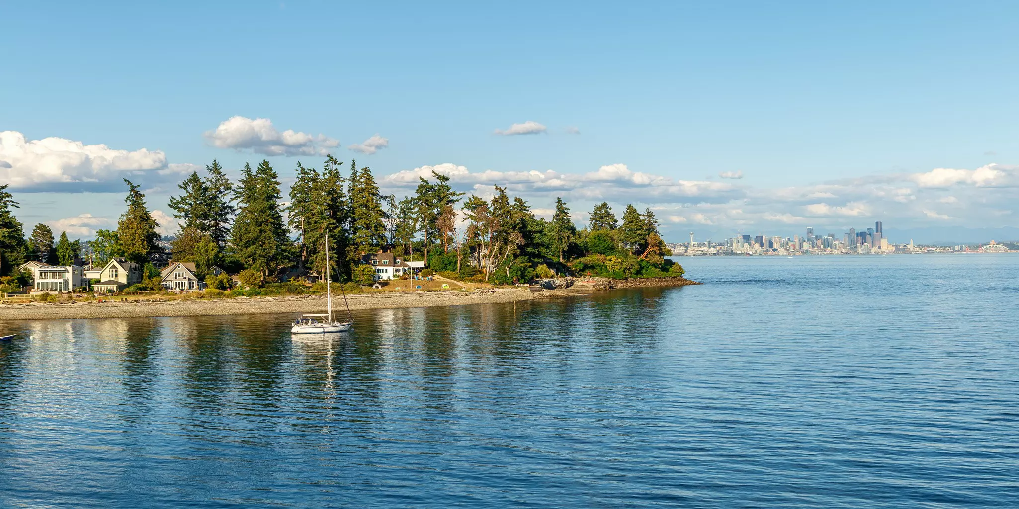Secluded residences on Bainbridge Island with the skyline of Seattle in the background.