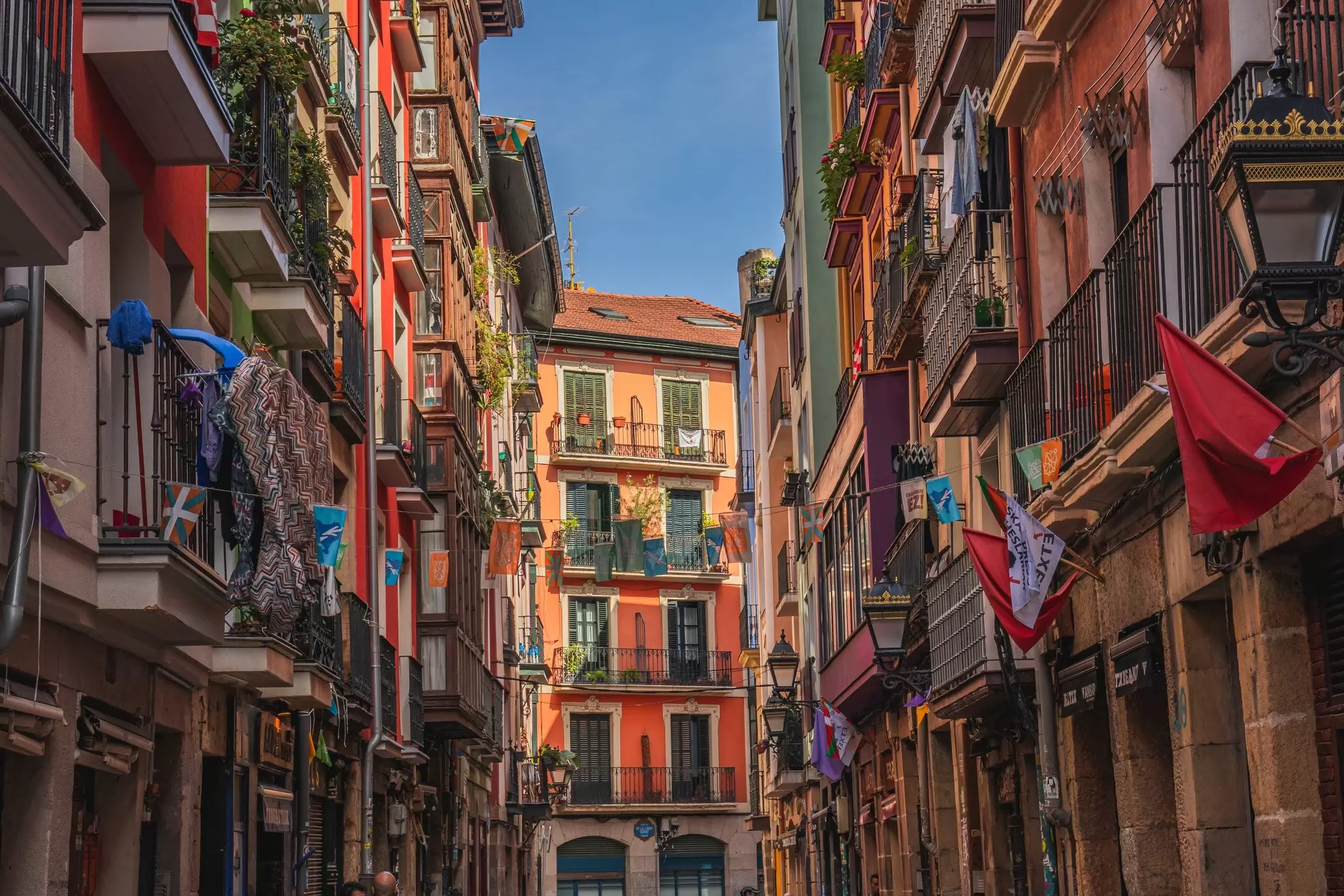 Bilbao, Spain. Multi colored houses, colorful street, beautiful flowers on balconies.