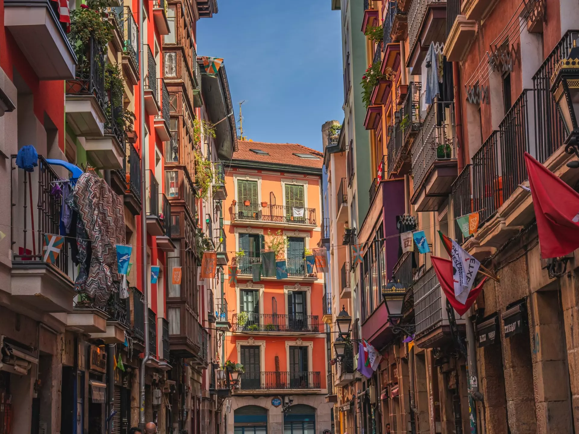 Bilbao, Spain. Multi colored houses, colorful street, beautiful flowers on balconies.
