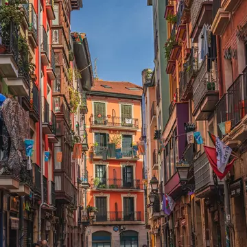 Bilbao, Spain. Multi colored houses, colorful street, beautiful flowers on balconies.