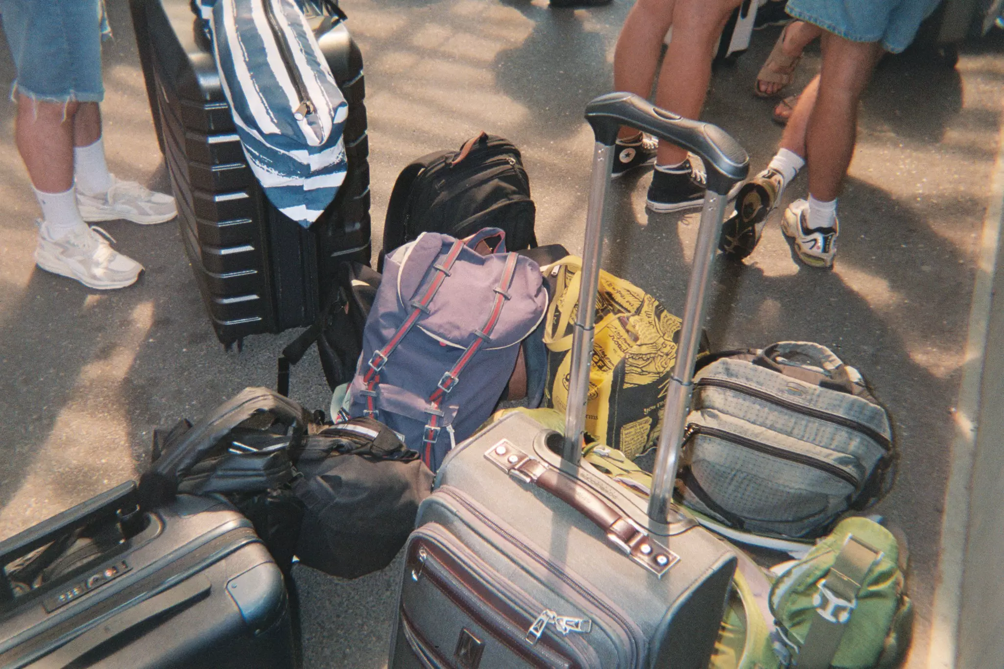Suitcases and bags grouped together while people wait to board the ferry to Fire Island.