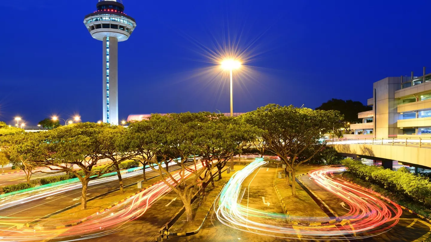 A traveler wearing PPE at Changi Airport