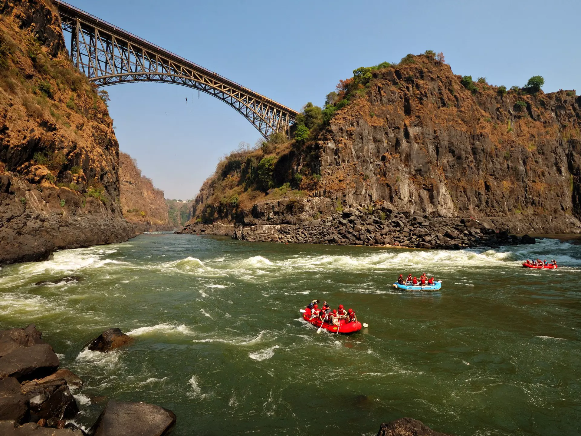 Rafters on the Zambezi River near Victoria Falls Bridge