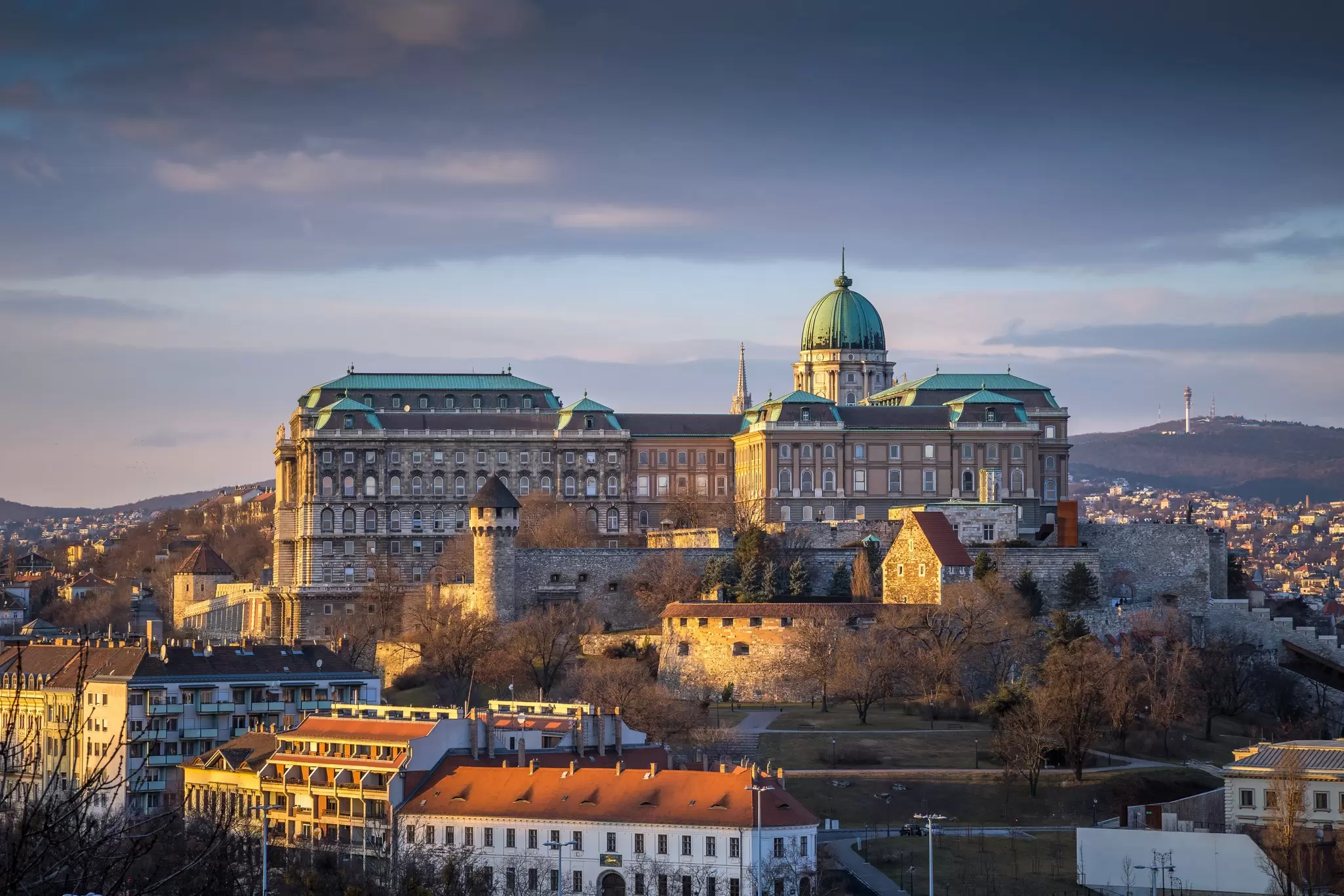 Buda Castle (Royal Palace), St. Matthias Church and Fisherman's Bastion at sunset as seen from Gellért Hill. ZGPhotography/Shutterstock
