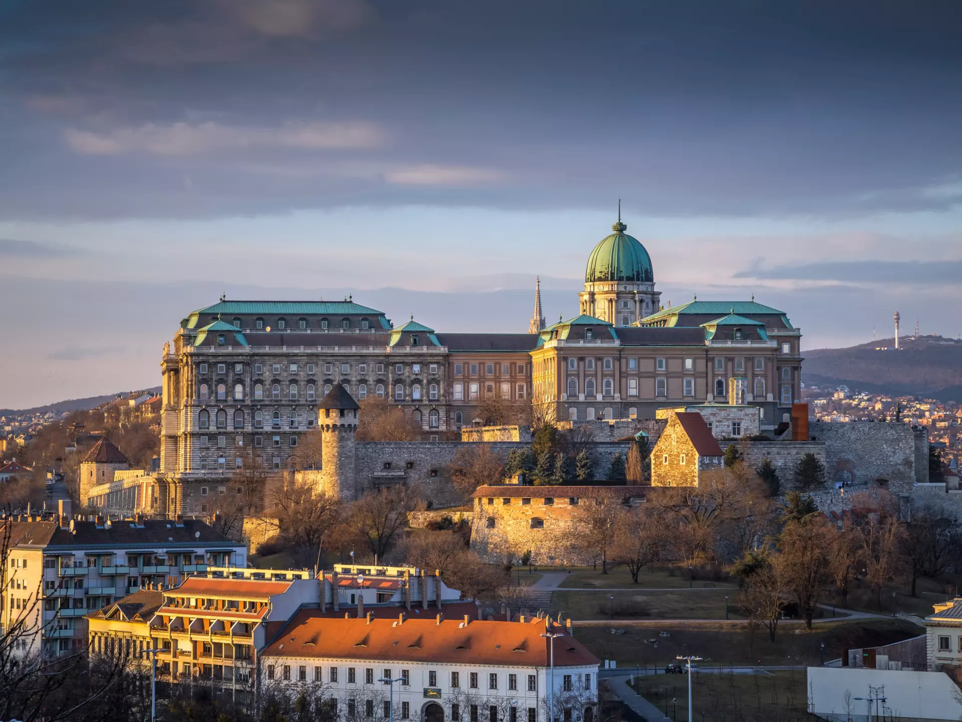 Buda Castle (Royal Palace), St. Matthias Church and Fisherman's Bastion at sunset as seen from Gellért Hill. ZGPhotography/Shutterstock