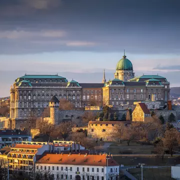 Buda Castle (Royal Palace), St. Matthias Church and Fisherman's Bastion at sunset as seen from Gellért Hill. ZGPhotography/Shutterstock