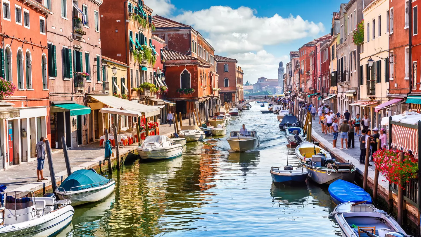 Visitors and boats in the canals of Murano Island