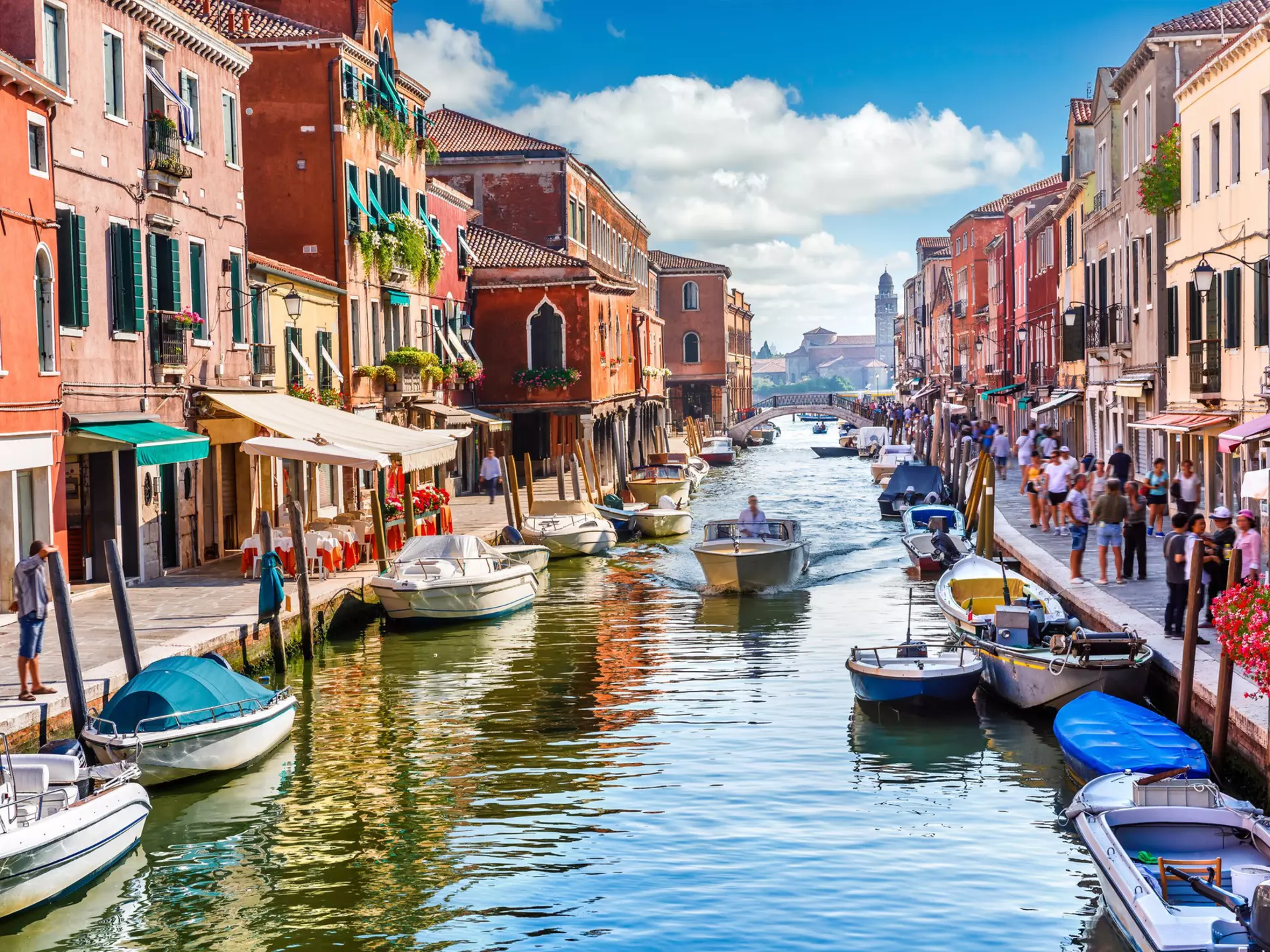 Visitors and boats in the canals of Murano Island